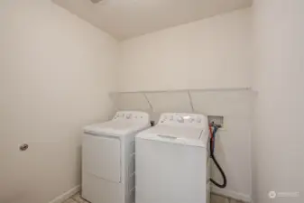 Laundry room, just off primary bedroom and garage.