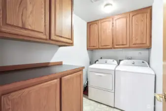 laundry room with lots of storage cabinets