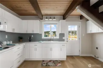 New Kitchen, sink, counters, cabinets, microwave...  Back door leads to large entertaining deck with BBQ hook up.