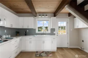 New Kitchen, sink, counters, cabinets, microwave...  Back door leads to large entertaining deck with BBQ hook up.