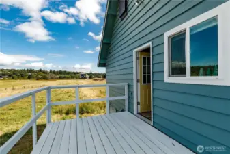 Back deck off kitchen is very spacious.  Can hold a good size table and chairs and lots of friends.