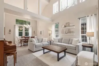 Light and open living and dining room off entry with vaulted ceilings.