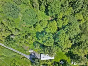 The long driveway, level backyard and some of the wooded trails can be seen here.