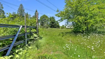 This gate leads to a very large fenced garden space.