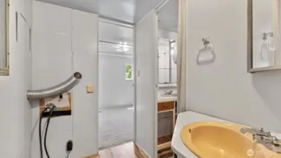 Space for a stackable washer and dryer on the left side at the end of the hall.