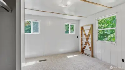 Primary bedroom at the end of the hall, closet is on the left.