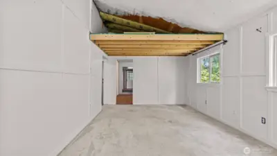 One more view of the living room and unfinished space for storage above.