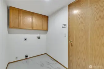 New flooring in the laundry. With the door to the garage on the right this space can double as a mud room.
