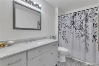 The upstairs hall bath is also updated.
