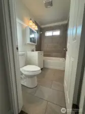 This bathroom really impresses with its blend of new tiling
