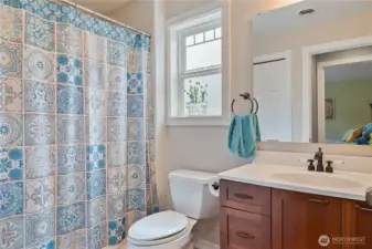 Hallway full Bathroom upstairs with it's own window and storage Closet (as seen in the mirror)