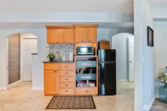 Those same stairs are behind the arch on the left, and some extra Storage plus a Bathroom is behind the arch to the right.  (Living area jaunts off to the right of the partial wall ....)