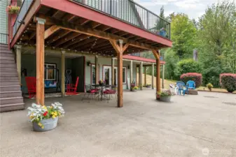 Out those doors to the right and you find multiple opportunities with cover, without cover, up top, down below, and all around the perimeter!  Covered cozy rocking chairs, and open air fire pits all ready for visiting or just relaxing!
