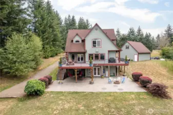 Not just a great pic of a great home, but this shot also shows the functionality that's attached to the (currently called) "Guest Suite".  The well-maintained driveway on the left leaves a place for your Guests (or RENTERS, or ?) to park below and walk across the flat patio and into what can be a private entrance to that awesome suite!