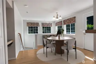 The expansive dining area provides seamless access to the downstairs recreation room, thereby enhancing the functionality and flow of the living space.