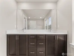 Double sink vanity, solid wood cabinets, quartz counters with undermount sinks. Actual home is under construction and materials, colors, and finishes will vary. See site agent for details.