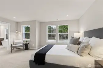 Primary bedroom with 5-piece attached bathroom and walk-in closet. Materials, colors, and finishes will vary. See site agent for details