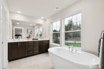 Attached 5-piece bathroom off primary with large soaking tub, double sink, walk-in shower.  Primary bedroom with 5-piece attached bathroom and walk-in closet. All and materials, colors, and finishes will vary. See site agent for details.