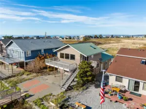 Two story home with upstairs living areas, metal roof, and great outdoor living spaces.