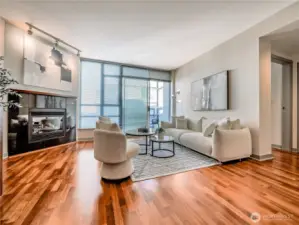 Step inside to sun-drenched interiors and a sleek fireplace that anchors the sophisticated open-concept living space. This is a staged photo