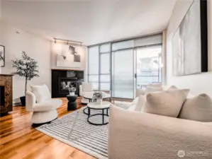 Massive windows frame the city’s vibrant pulse, making the skyline a permanent part of your daily decor. This is a staged photo