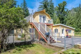 Multiple outbuildings including ADU, dog kennels, 9 fenced dog yards, grooming room, bathrooms, garages, shops, office space.