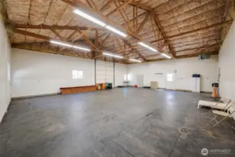 2nd large building behind the admin building. This one is currently the dog training/daycare/excercise room, Extra large garage with tall roll up door. Continue using with dogs or maybe this is where you park all your classic cars?
