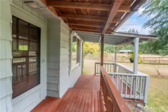 Front door and front porch that leads to both ends of the home.