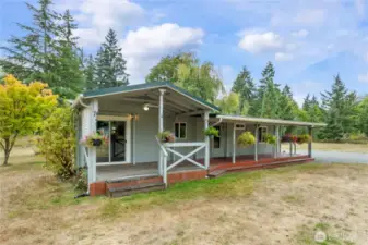 The back of the home boasts huge wood porch fully covered to enjoy year-round!