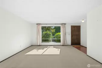 Front entry to living room, coat closet across from door.