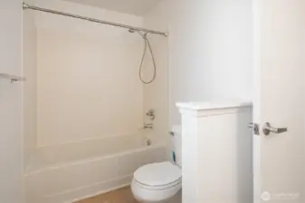 The primary bathroom is bright with new paint and new flooring.