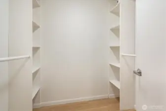 The primary features a large walk in closet with built in shelving.
