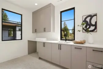 Upper Level Laundry Room with plenty of Cabinet/Counter Space
