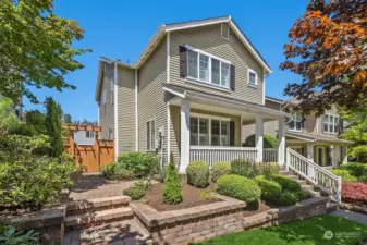 Desirable 2-story Craftsman home with a charming paved side pathway that leads to the backyard.