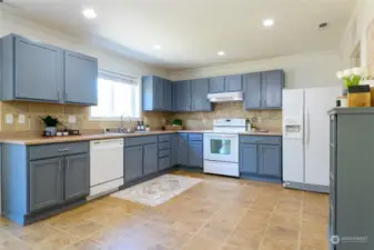 The kitchen in this home is truly expansive, offering an abundance of space for both cooking and entertaining. The large kitchen features a generous layout with ample countertops and cabinetry, providing plenty of storage for all your kitchen essentials.