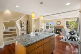 Kitchen with eating bar, dining room, living room and deck