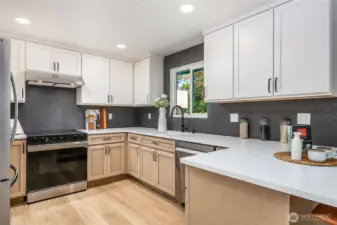 The kitchen boasts custom cabinetry and all-new appliances, offering both style and functionality for the home chef.