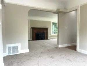 Standing in the dining room area and looking towards the living room area. The kitchen doorway is to the right. You can see the furnace air return here. There is a brand new American Standard furnace installed in the basement.