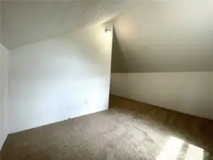 The upper fourth bedroom features new carpet and lighting and is freshly painted.