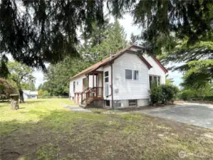 From the road and looking towards the house, you can see the back entry and the expansive side yard.