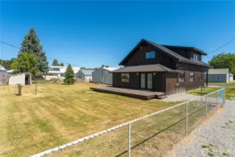 Large partially fenced back yard, goes to alley road