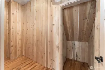 Primary bedroom walk in closet with cedar walls