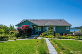 Enter through the garden gate & follow the stepping stones to the front door. Enjoy the beautiful landscaping along the way!