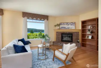 Large living room with a wood burning fireplace to relax & enjoy the water views!