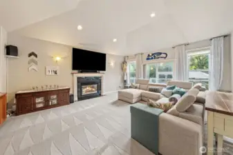 Family room with gas fireplace, vaulted ceilings and large windows providng an abundance of natural light.