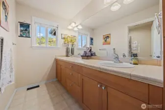 Main bathroom with double sinks and bathtub.