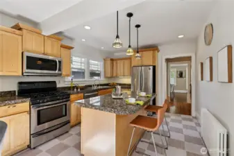 Spacious sunny kitchen with pendant lights and granite countertops