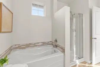 Large soaker tub with tile accents.