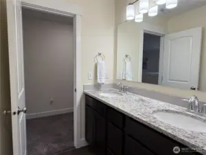 Upstairs hall bathroom features double vanity