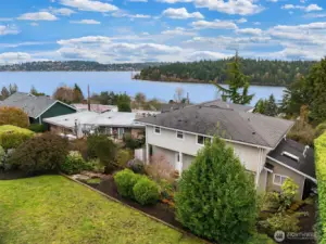 Lawn at the top of the tiered lot.  With views of water.